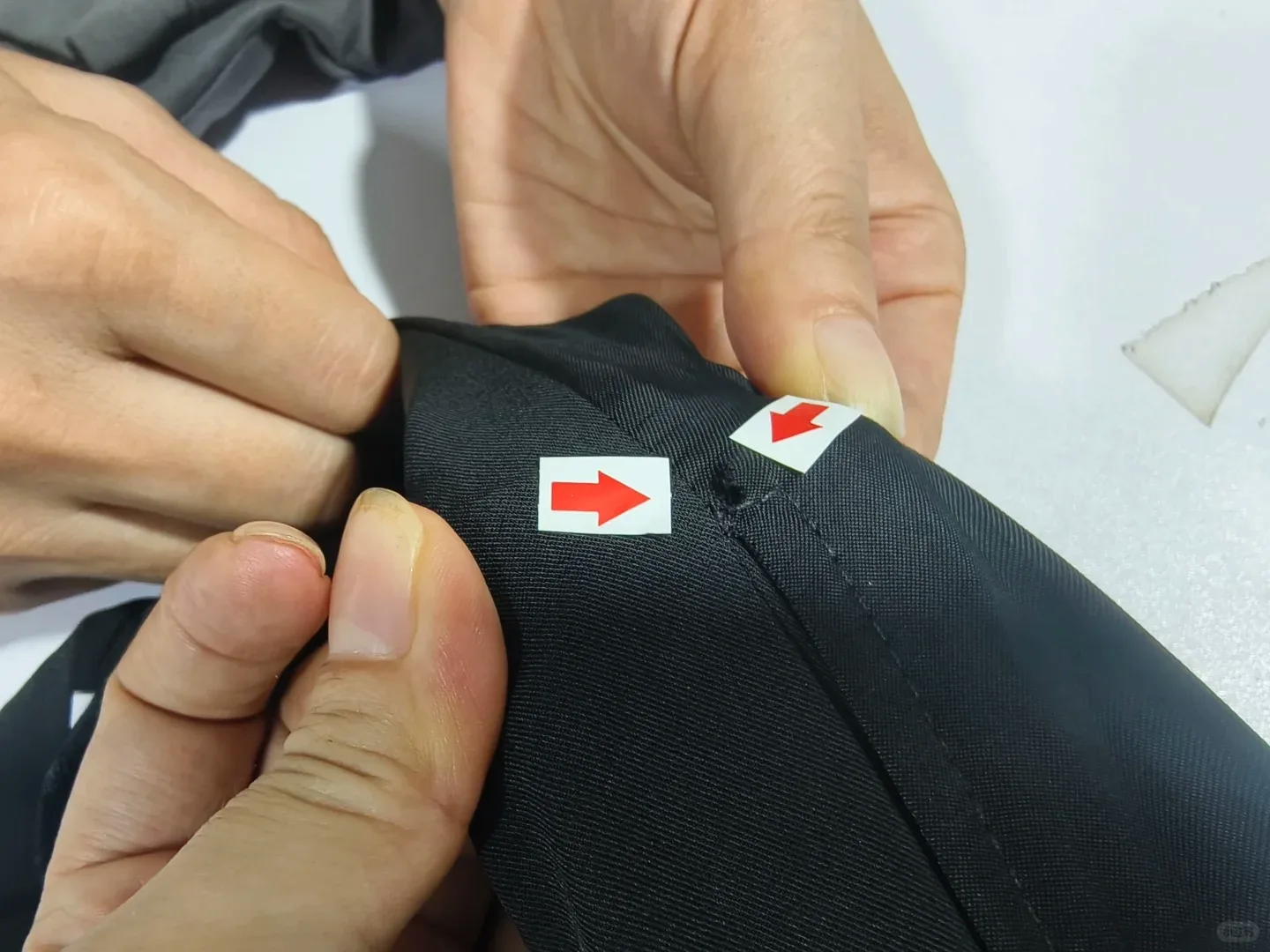 Garment stitching being checked during quality inspection