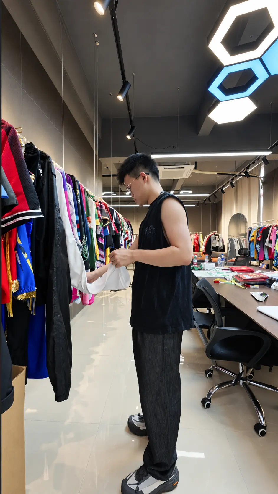Derrick reviewing garments inside a specialist apparel factory showroom