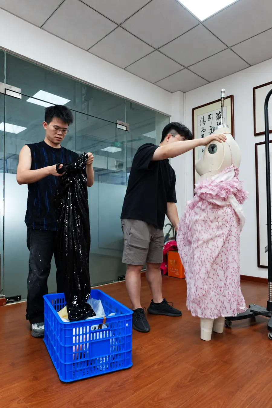 Sample makers draping and developing a garment on a dress form