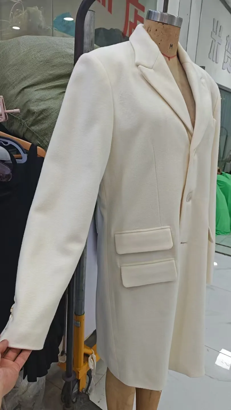 Tailored ivory jacket sample on a dress form