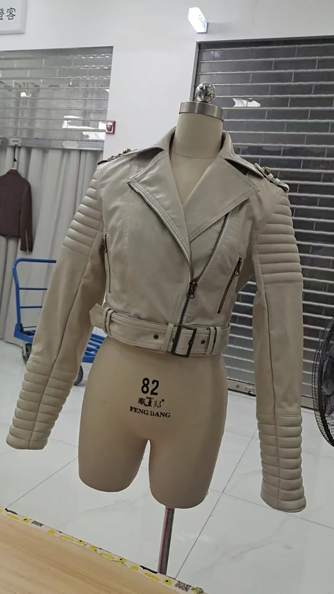 Fitted jacket sample with constructed sleeves on a dress form