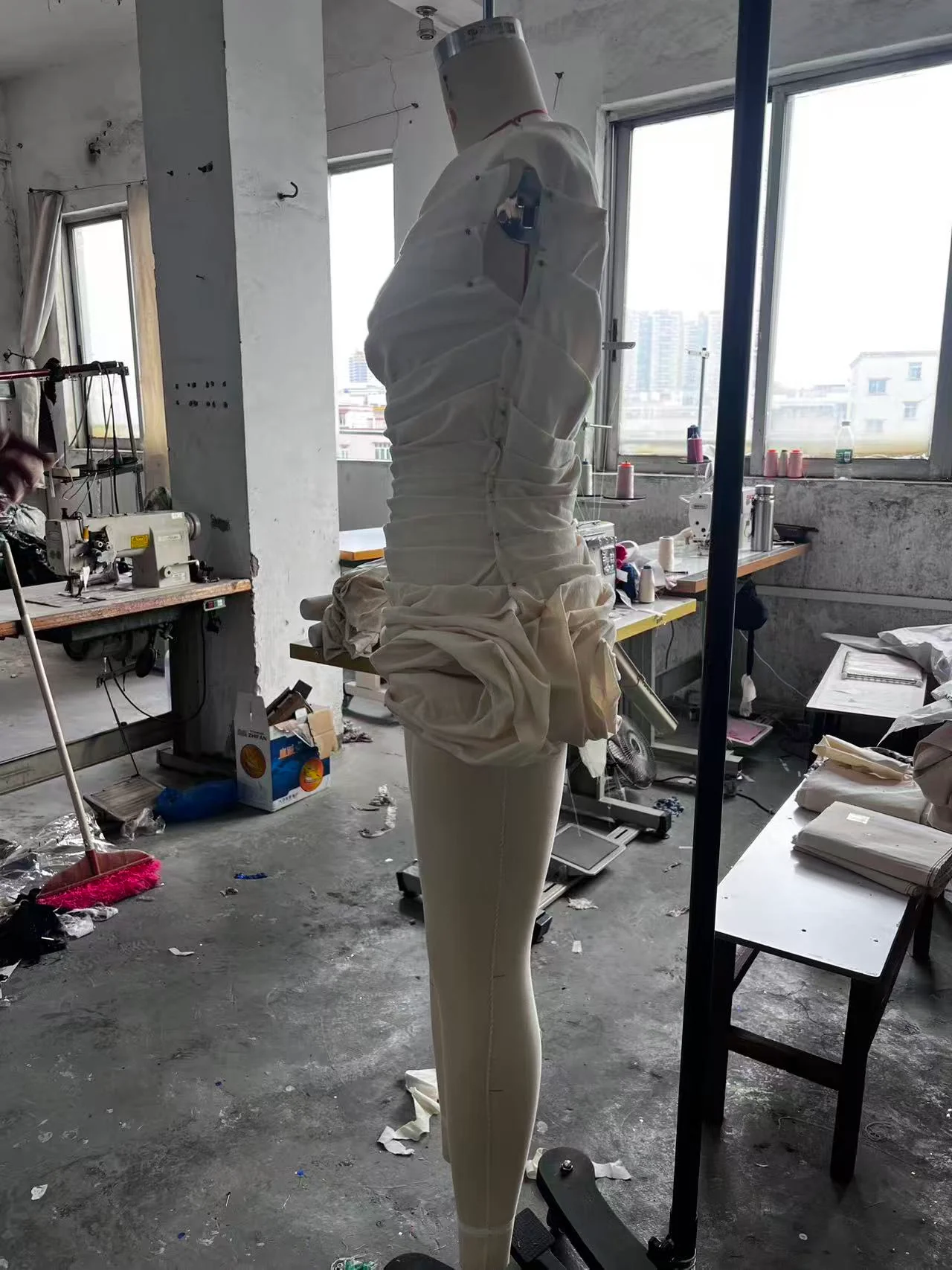 White muslin first toile viewed from the side