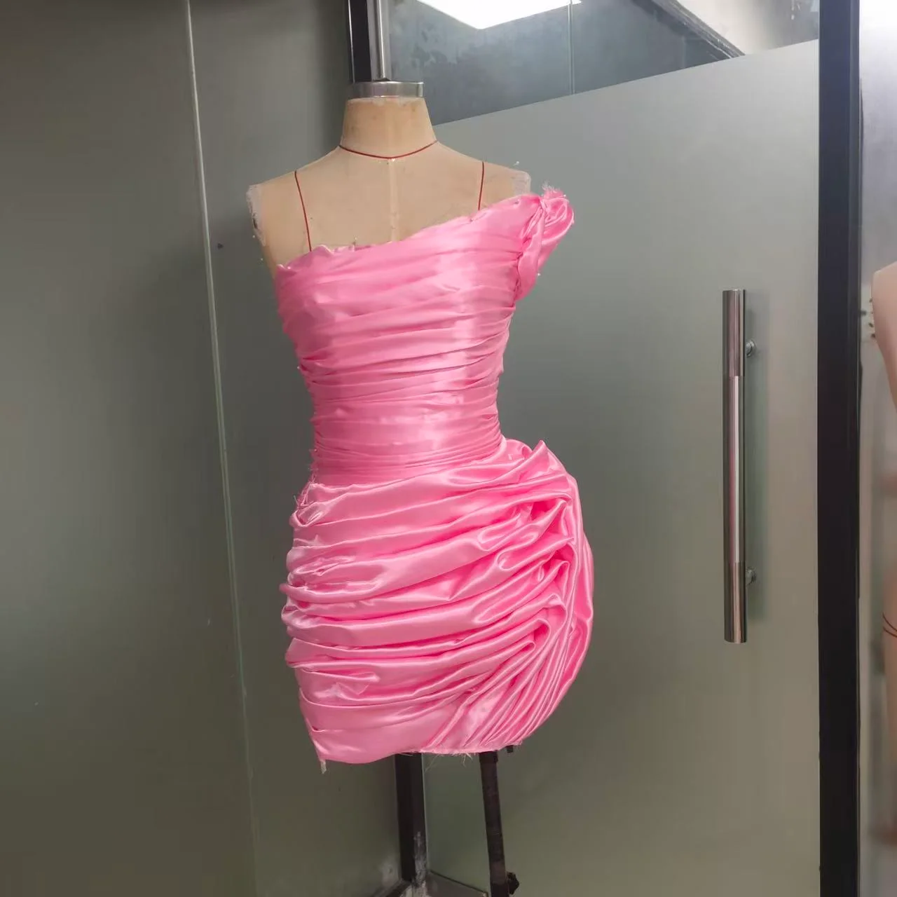 Pink revised toile on a dress form, front view